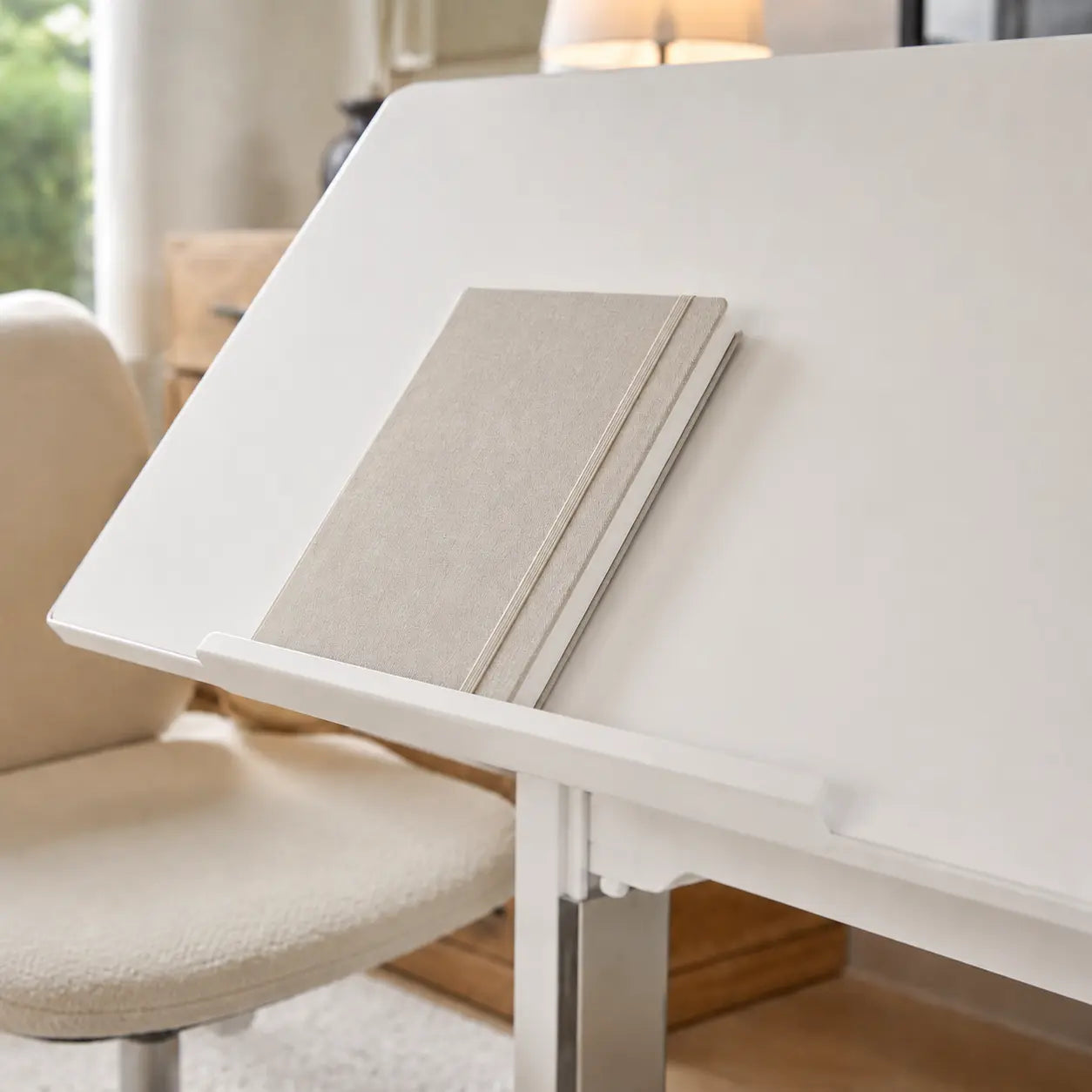 Workstation tabletop tilted to an adjustable working angle
